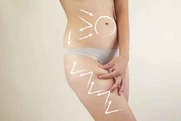 female body closeup highlighted with arrows showing massage line
