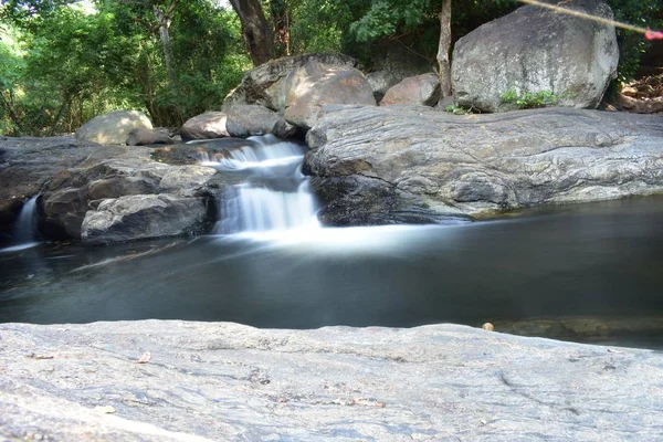 Kumbakkarai Water Falls e o rio Pambar fluem ao longo das rochas — Fotografia de Stock