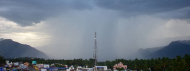 Rain shower falling from dark cumulus clouds clipart