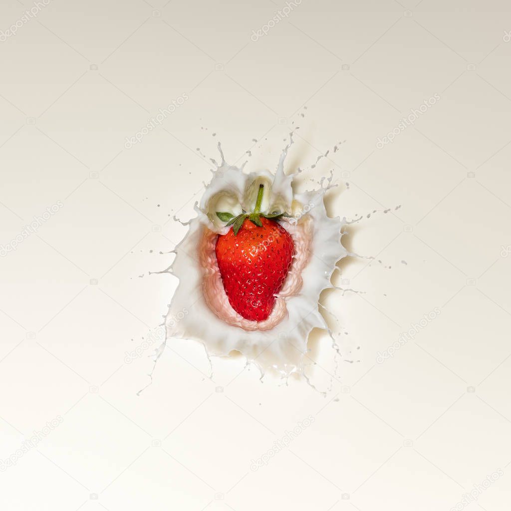 Fresh Red Strawberry fruit splash in white milk and viewed directly from above