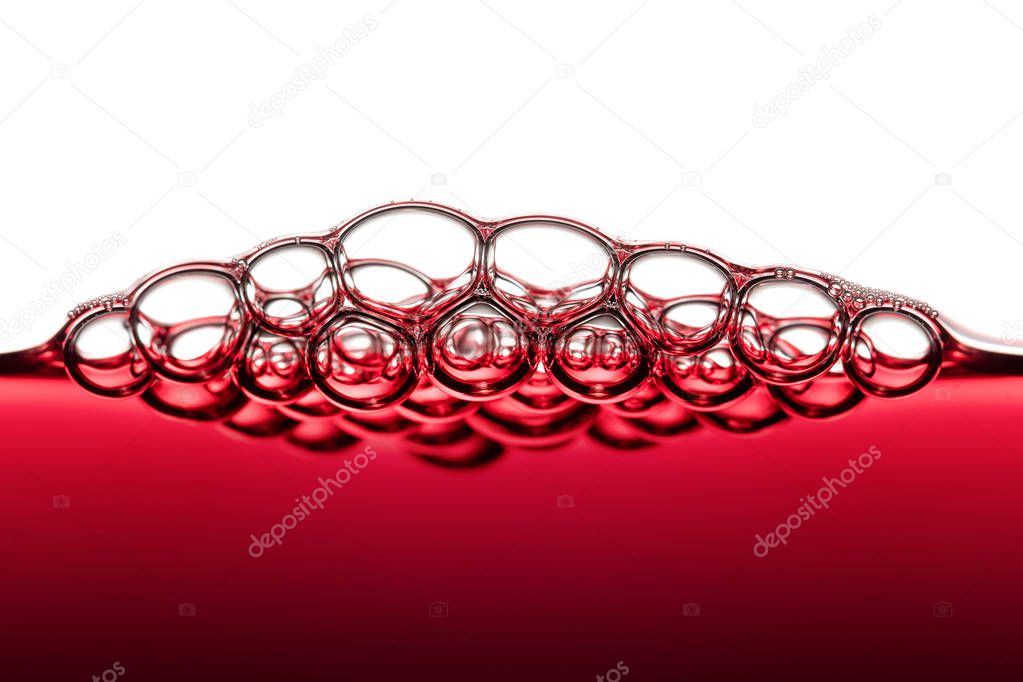 Abstract Food Art Pattern of Red Wine Bubbles photographed close-up against white background