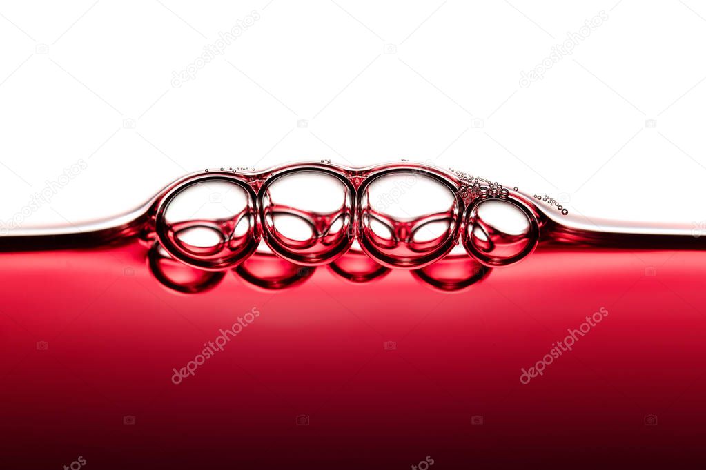 Abstract Food Art Pattern of Symmetrical Red Wine Bubbles photographed close-up against white background
