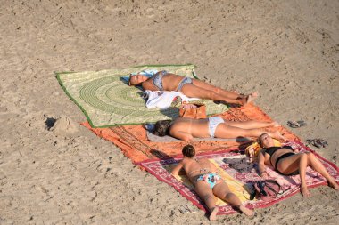 ORIHUELA, COSTA BLANCA, SPAIN - 23 Eylül 2018: Orihuela Costa sahilinde güneşlenen kadınlar. İspanya