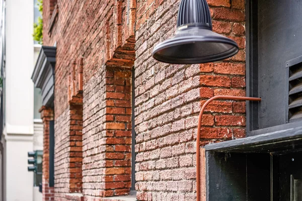 Wall of red brick and street lamp, San Francisco, USA