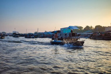 Can Tho, Vietnam - 28 Mart 2019: Mekong nehri boyunca gün doğumu-seyir delta ticaret teknelerde Mekong yüzen pazar. Tekneyi süren balıkçı