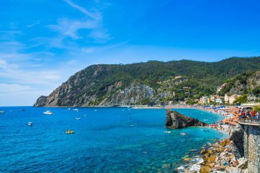 Monterosso al Mare, La Spezia eyaleti, İtalya - 17 Ağustos 2019: yaz sezonunda şehir plajı / Liguria'da büyük plaj / İtalya'da tatil / Cinque Terre / denizde çıkıntılı kayalıklar, tekneler ve yatlar