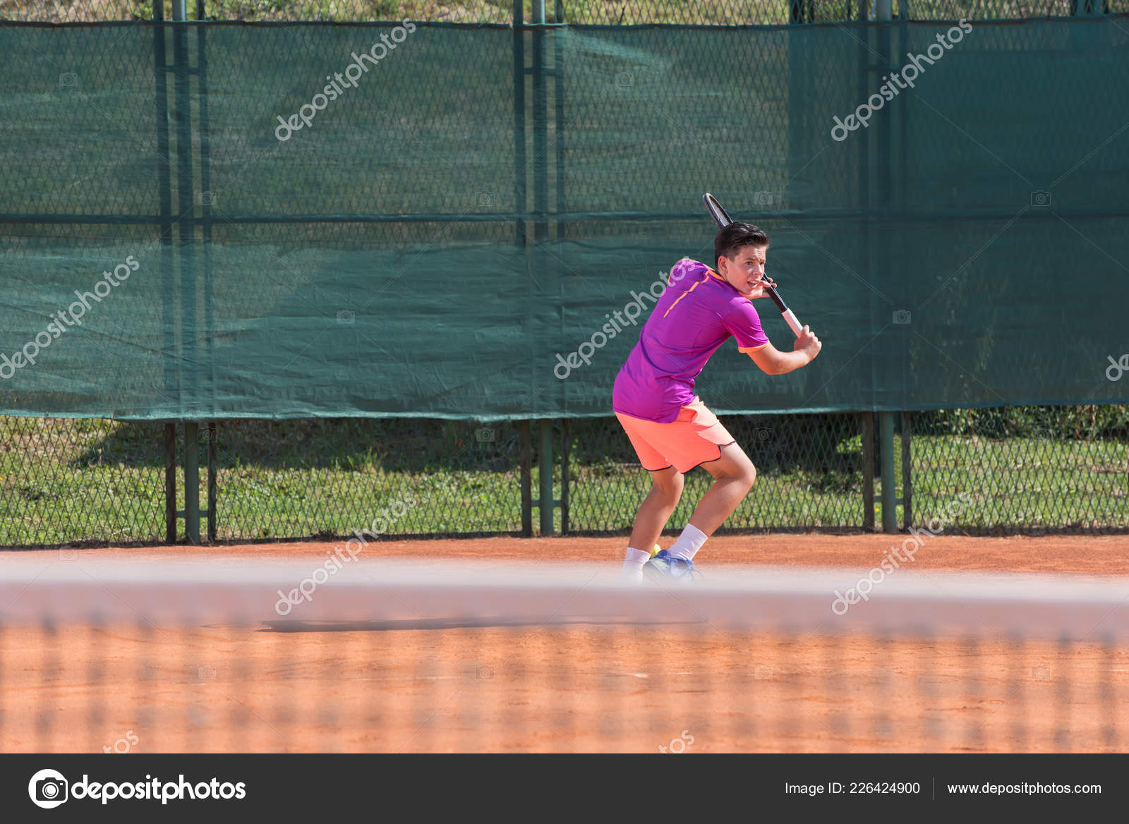 Young Tennis Player Hitting Ball Stock Photo by ©cirkoglu 226424900