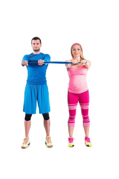 Glückliches junges Paar macht paarweise Sport mit elastischem Gummi für die Schwangerschaft auf weißem Hintergrund. — Stockfoto