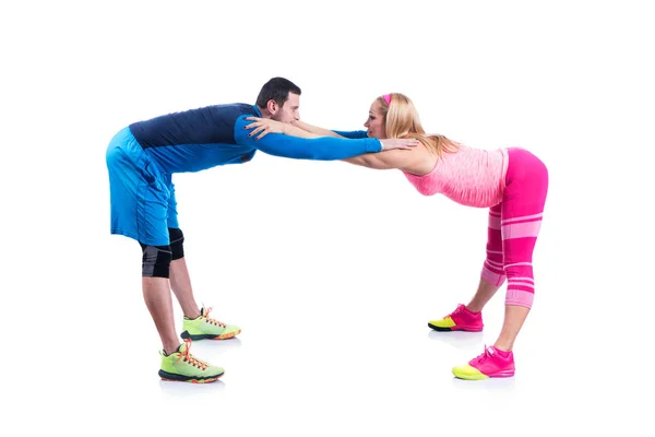 Happy young couple doing exercise in pair for pregnancy on the white background. — Stock Photo, Image