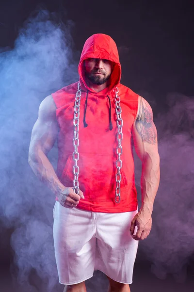 Δυνατός Μυώδης Άντρας Κουκούλα Και Αλυσίδα Που Ποζάρει Την Κόκκινη — Φωτογραφία Αρχείου