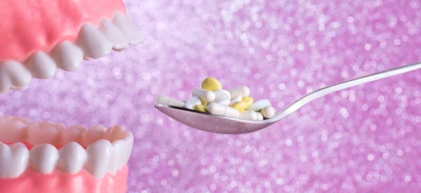 Açık ağız, diş ve kaşık hapları vitamin veya aşırı doz alarak dolu