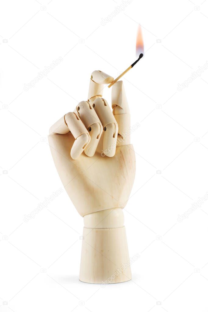 A wooden hand with a lighted match on a white background