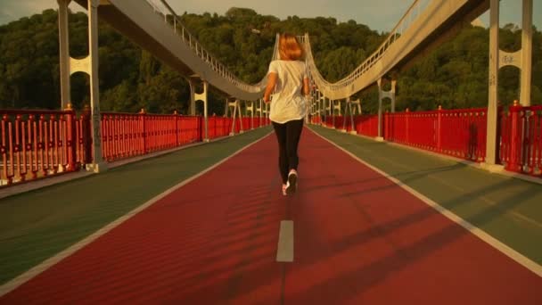 Feminino corredor corre na ponte — Vídeo de Stock