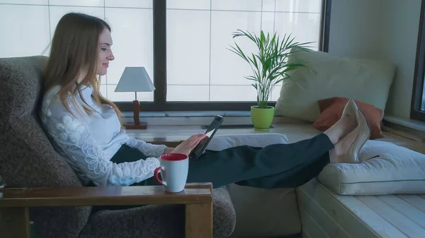 Smiling Woman Watching Funny Photo On The Tablet