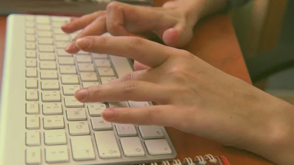 Female hands typing on a white keyboard. — Stock Photo, Image