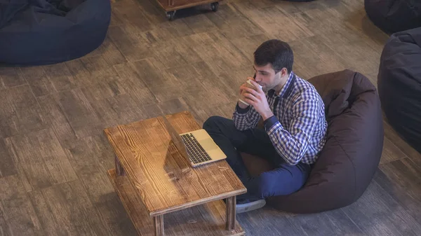 Concentré sur le travail d'un homme parlant au téléphone et travaillant sur son ordinateur portable . — Photo