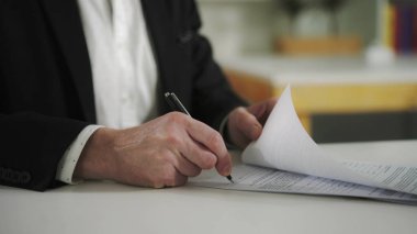 Businessman signs documents clipart