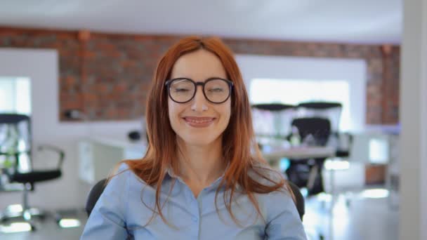 Portré vöröshajú nő azt mutatja, hogy csók a munkahelyen — Stock videók