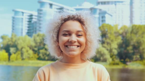 Portrait mixed race woman chortling in city — Stock Video