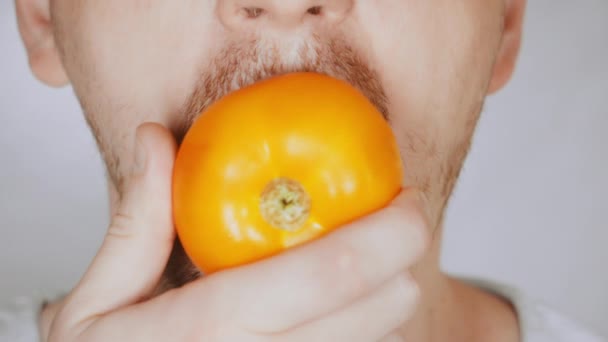 Close up cara justo homem come tomate — Vídeo de Stock