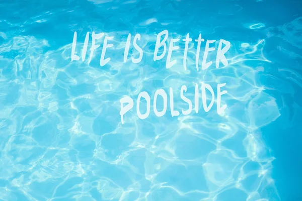 Surface of  pool water with quote life is better poolside — Stock Photo, Image