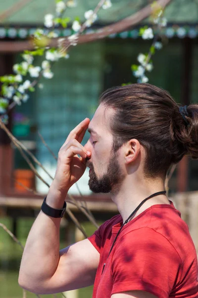 Young man practice yoga breathing technique summer day by the la — Stock Photo, Image