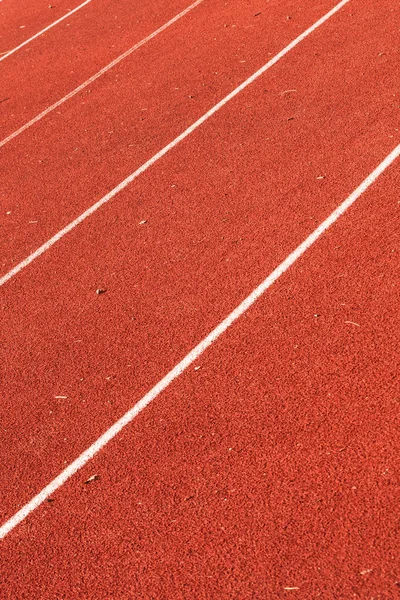 Closeup of athletic red running tracks whit white lines — Stock Photo, Image