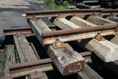 Old exchanged wooden railway sleepers stored for further use clipart