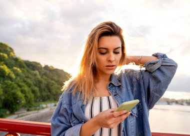 gün batımında kız serbest meslek telefon ve eserler üzerinde konuşuyor