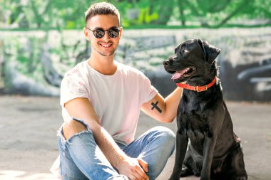 adam parkta oynarken onun köpek labrador ile sarılma