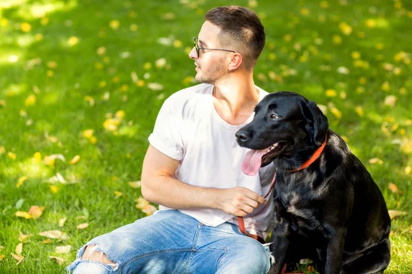 Facet Przytulanie Jego Pies Labrador Grając Parku — Zdjęcie stockowe