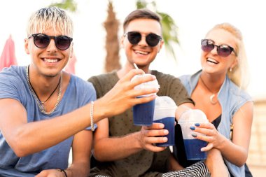 üç arkadaş sahilde kokteyl eğlenceli içme