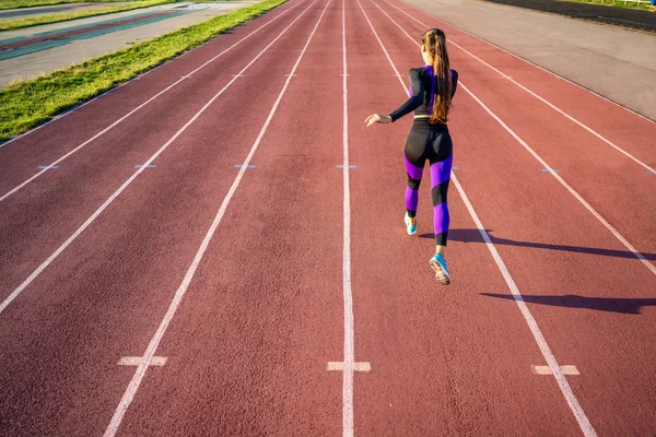女孩运动员在体育场的日落和奔跑 — 图库照片