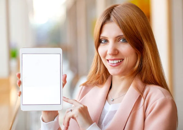Girl freelancer holding a tablet in the office — Stock Photo, Image