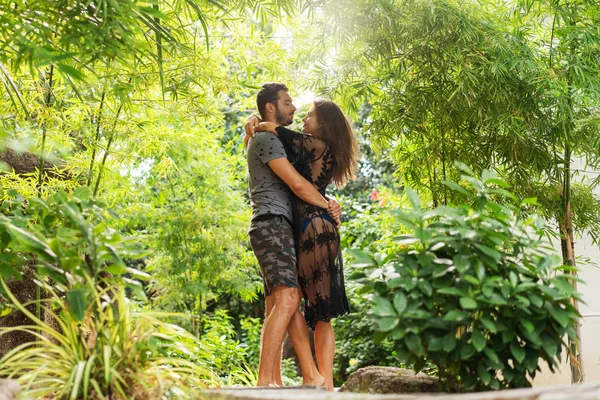 Couple amoureux sont debout au coucher du soleil dans la jungle — Photo