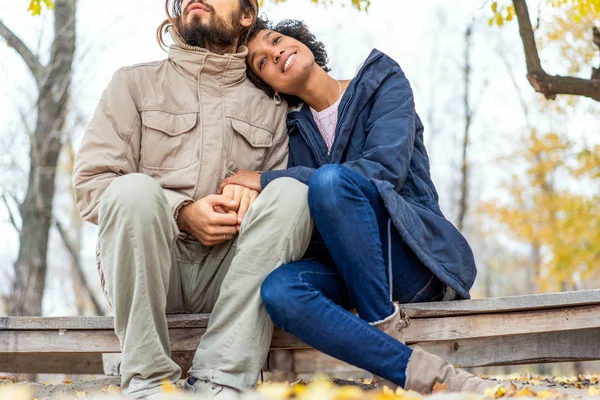 Kerl mit einem verliebten afrikanisch-amerikanischen Mädchen beim herbstlichen Parkspaziergang bei Sonnenuntergang — Stockfoto