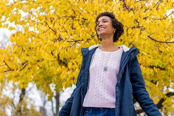Afro girl in autumn park outdoors smiling — Stock Photo, Image