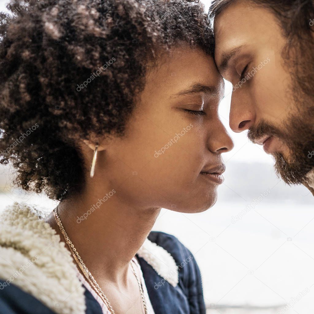 guy with an african american girl in love in autumn park walk at sunset