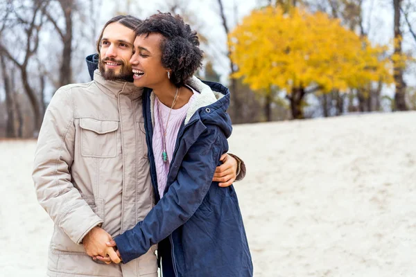 Kerl mit afrikanisch-amerikanischem Mädchen in Herbstpark verliebt macht ihr ein Heiratsangebot — Stockfoto