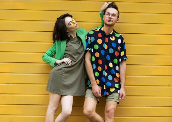 Giovane coppia alla moda su sfondo giallo — Foto Stock