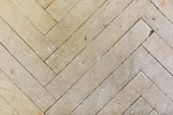 A close-up of an old gray faded parquet covered with dust and dirt. Result of repair. Cleaning and cleaning required — Stock Photo, Image