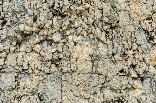 Kamienia teksturowanej tło gruzu balastu w postaci naturalnej w skalnej ściany — Zdjęcie stockowe