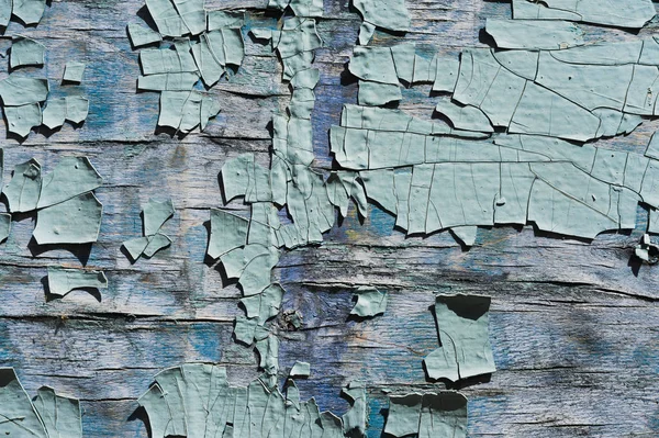 Textured background cracked blue paint on a wooden surface — Stock Photo, Image