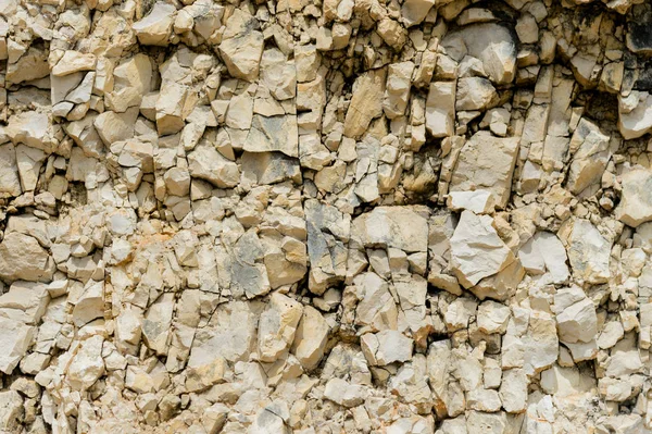 Dokulu taş doğal kaya duvarı formunda moloz balast arka plan.