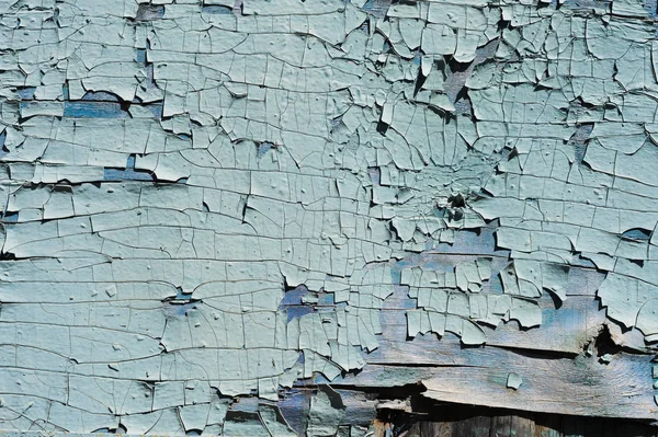 Fondo texturizado agrietado pintura azul sobre una superficie de madera — Foto de Stock