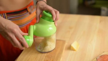 Ahşap bir masa üzerine saydam bir cam ile özel mekanik rende içinde peynir bir genç kız losyonları