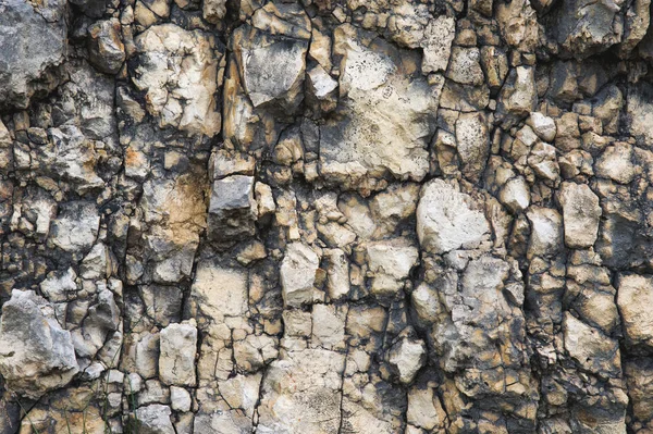 Fondo de piedra texturizada Balasto de escombros en forma natural en la pared de roca — Foto de Stock