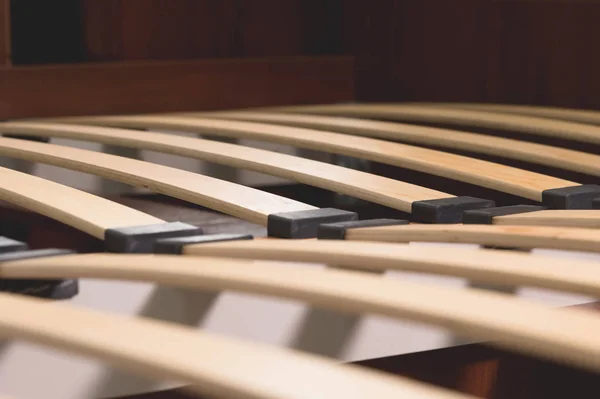 Close-up wooden elements of an arthopedic base of a double bed. Interior structure of furniture — Stock Photo, Image