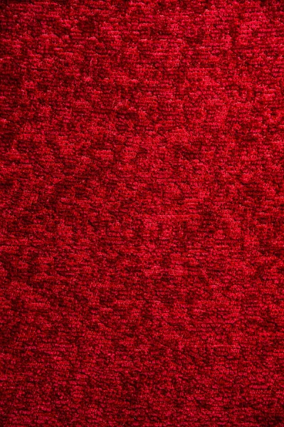 Textura de um tapete vermelho escuro. Close-up de luz gradiente — Fotografia de Stock