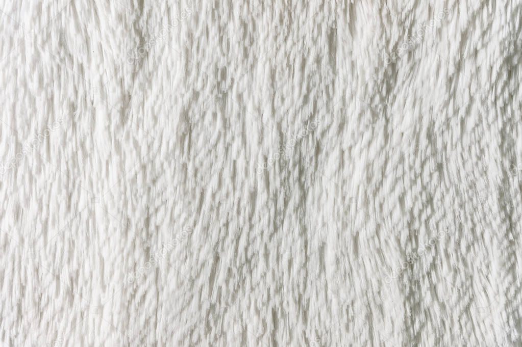 Fluffy plaid of polyester with a long heap gray. Comfortable home textiles. Background, texture